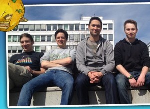 four people sitting outside, on a concrete bench